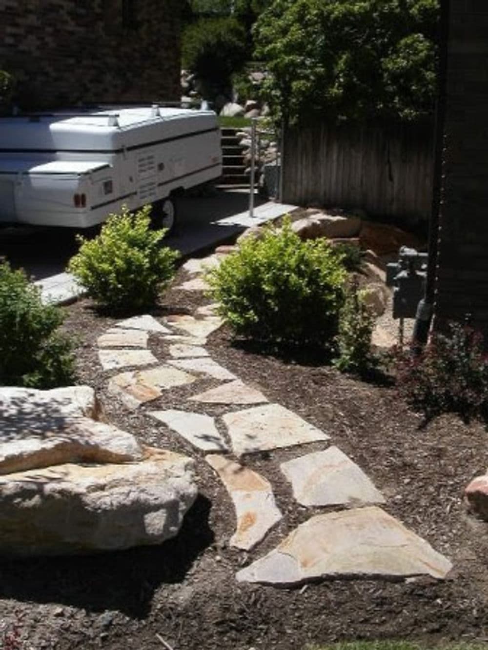Retaining wall and paver patio designed by Avant Garde.